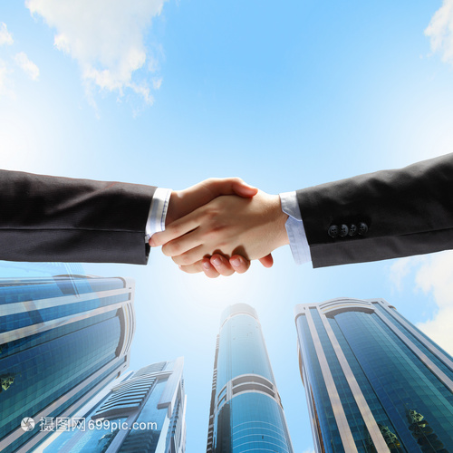 商務握手近距離的手與摩天大樓的形象